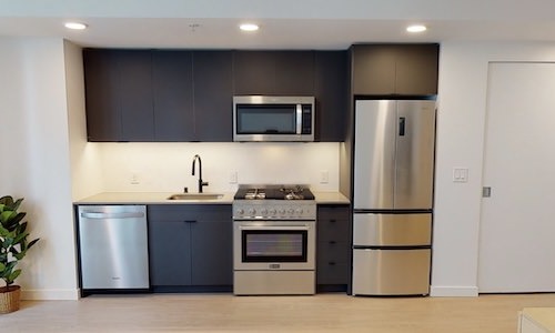 a kitchen with dark cabinets