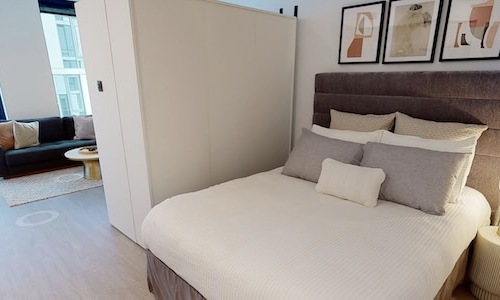 a bed in a studio apartment