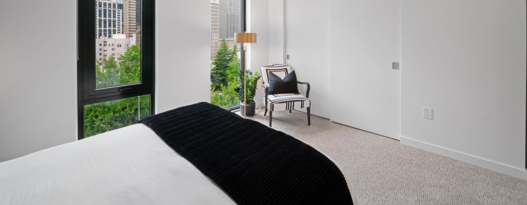 a bedroom with a bed and a chair